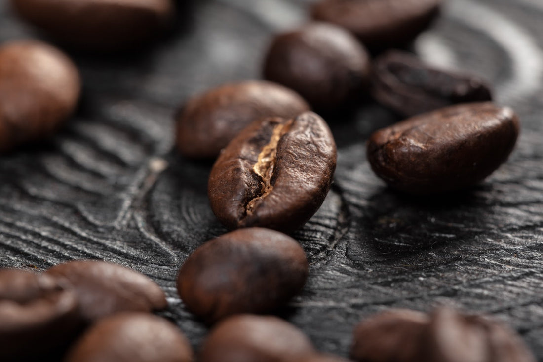 Coffee beans on wood, close up.