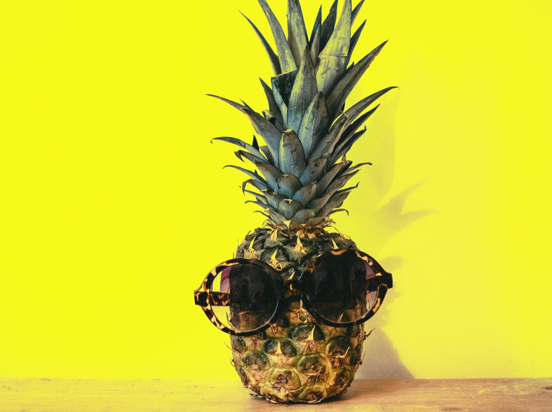 Ripe pineapple wearing sunglasses.